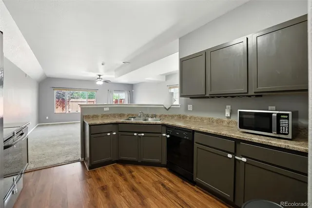 a kitchen with a refrigerator and a stove