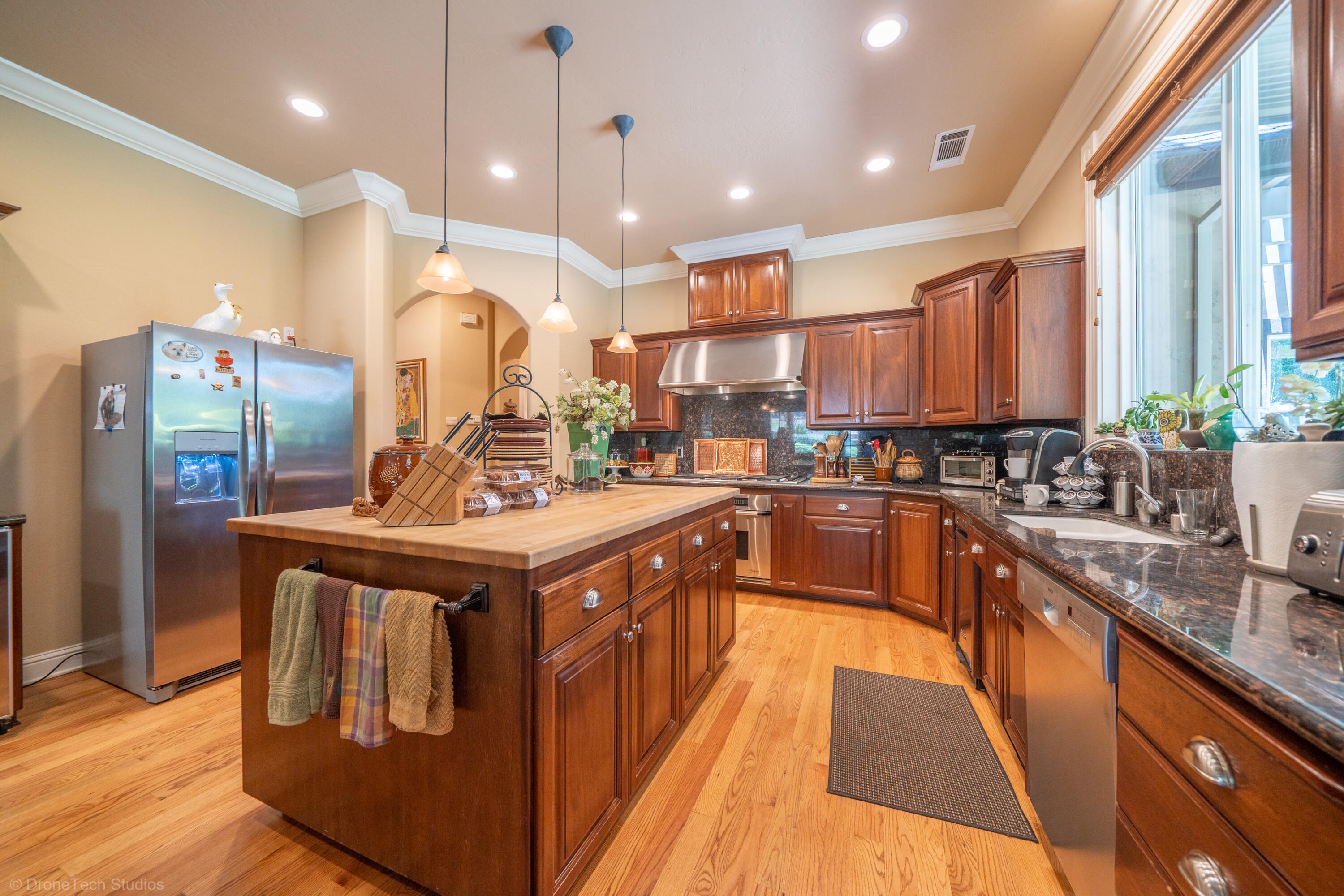 9109 Simmons Road Redding, CA 96001 - Photo 11 of 52 a kitchen with stainless steel appliances granite countertop a sink a stove and a refrigerator