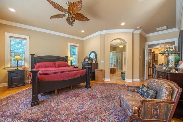 a spacious bedroom with a bed and a chandelier