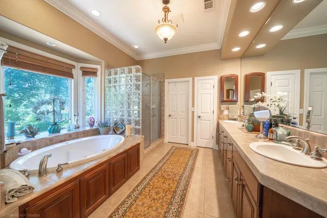 a spacious bathroom with sink shower and bathtub