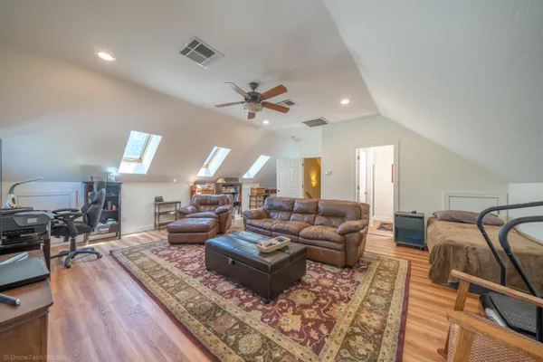a living room with lots of furniture and a wooden floor