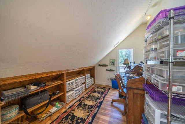 a view of gym equipment and wooden floor