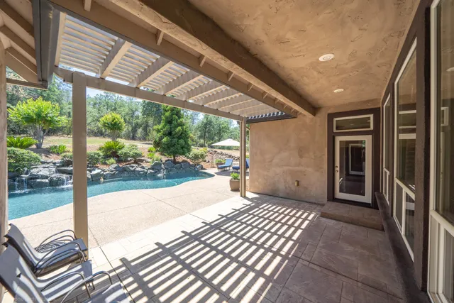 a view of a porch with wooden floor and roof