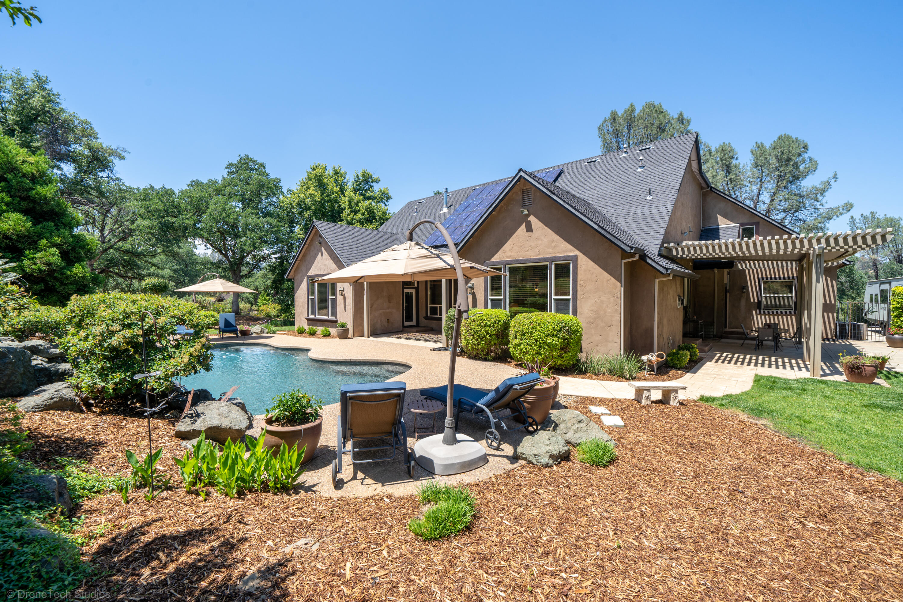9109 Simmons Road Redding, CA 96001 - Photo 36 of 52 a front view of a house with garden