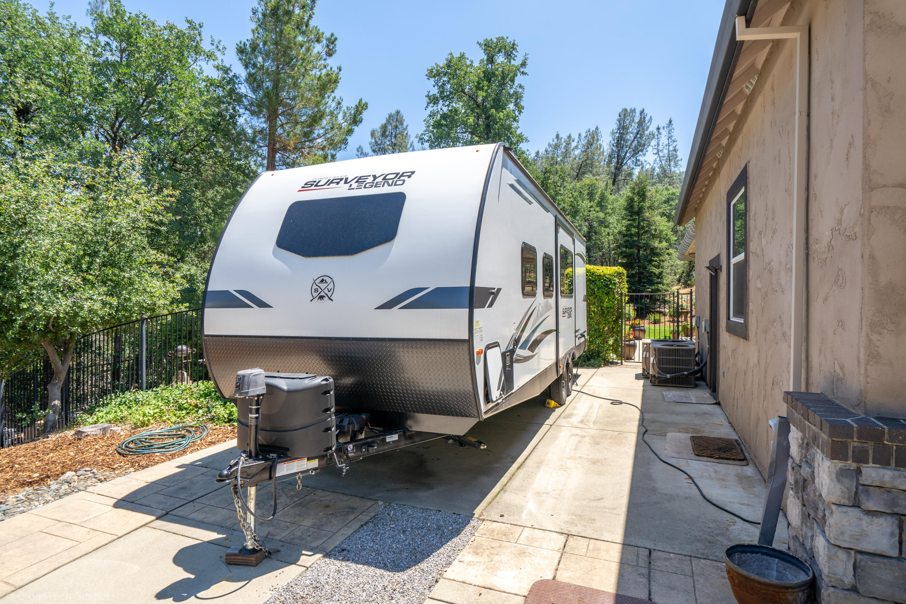 9109 Simmons Road Redding, CA 96001 - Photo 41 of 52 a view of a patio with table and chairs potted plants with wooden floor