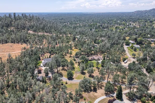 an aerial view of a house with a yard