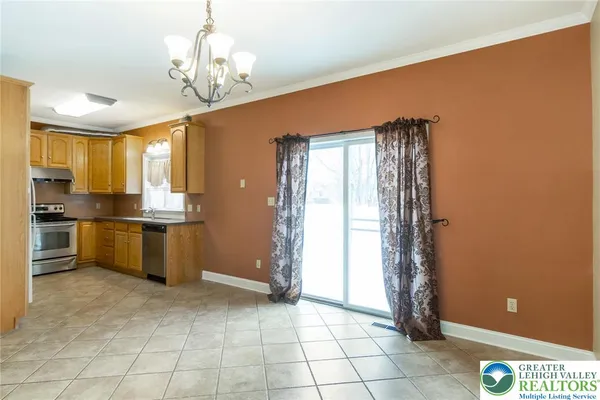 a view of a kitchen with stainless steel appliances granite countertop a refrigerator and a stove top oven