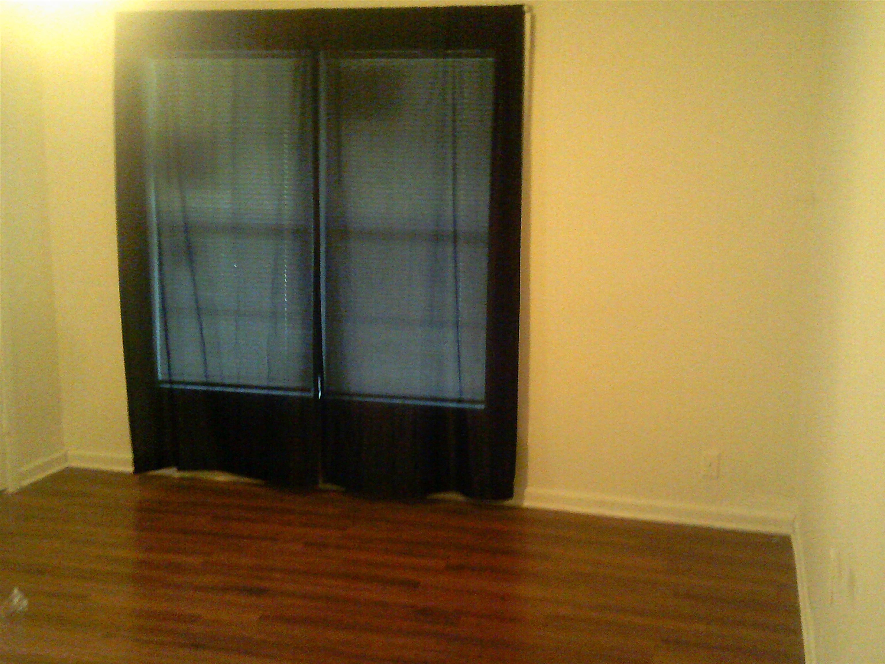 783 Nonconnah Road Memphis, TN 38109 - Photo 4 of 11 a view of an empty room with wooden floor