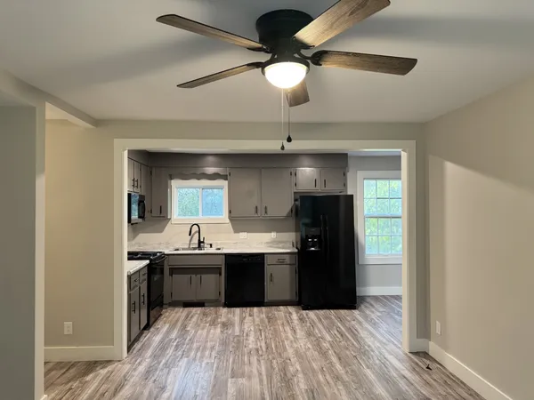 a kitchen with kitchen island a sink and wooden floor