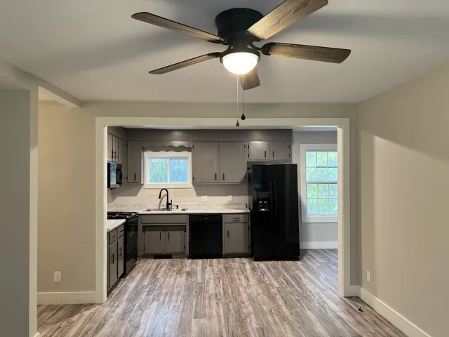a kitchen with kitchen island a sink and wooden floor