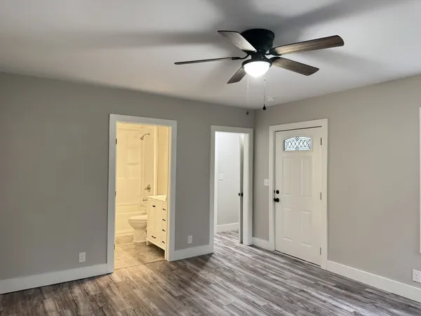 wooden floor in an empty room with a window