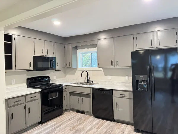 a kitchen with a sink stove and refrigerator