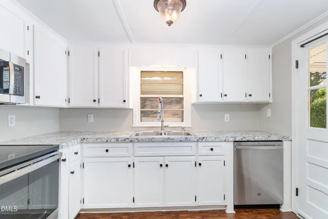 a front view of a house with yard and seating area
