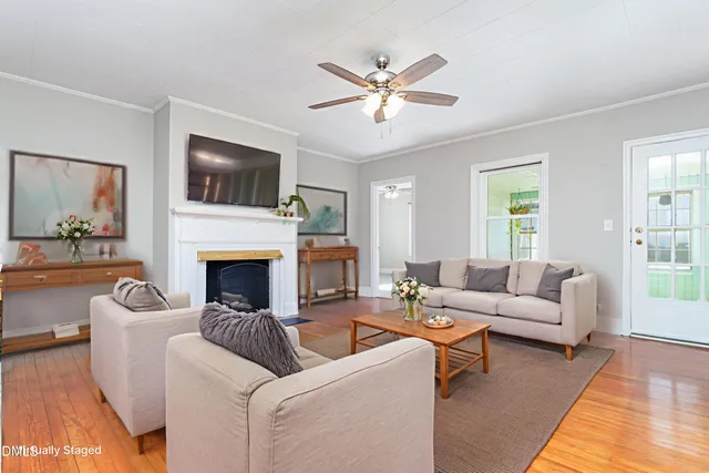 a living room with furniture a fireplace and a flat screen tv