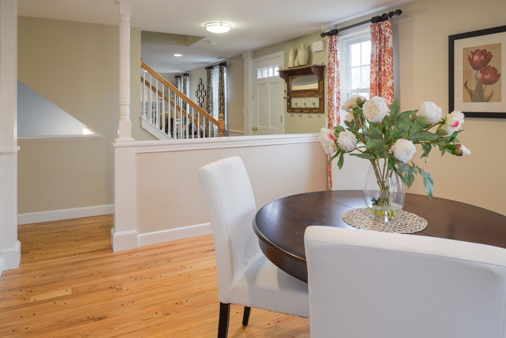 49 Margaret Road Hamilton, MA 01982 - Photo 8 of 22 a dining room with furniture potted plants and wooden floor