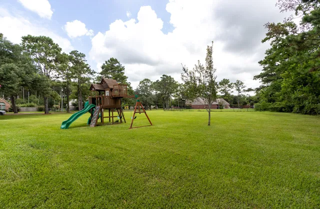 a view of a park with swings and slides