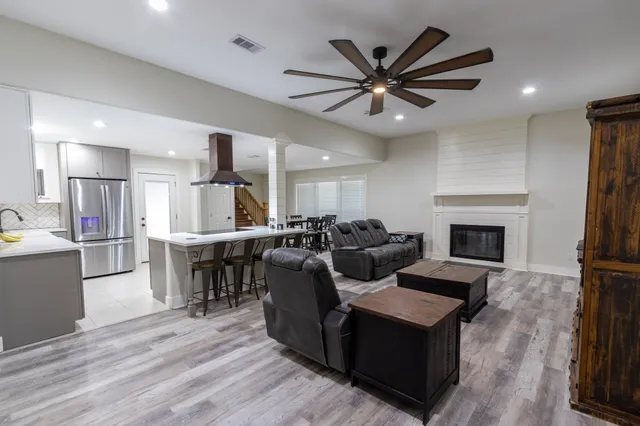 a living room with furniture kitchen view and a fireplace