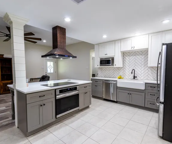 a kitchen with a sink stove and refrigerator