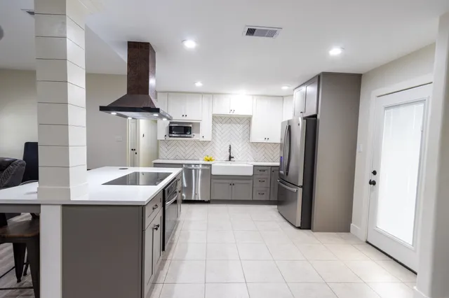 a kitchen with stainless steel appliances a sink stove and refrigerator