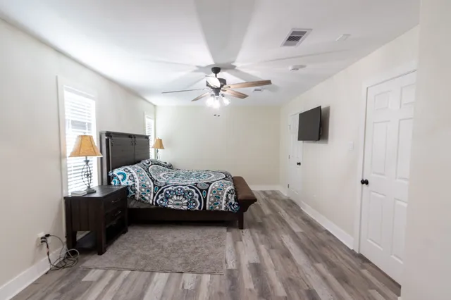 a bedroom with a bed and a chandelier