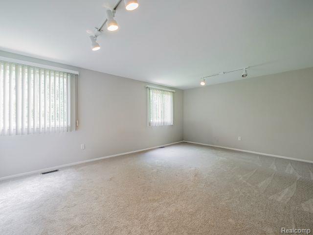 21728 Ruth Street Farmington, MI 48336 - Photo 36 of 54 Spacious room featuring neutral carpeting and light gray walls