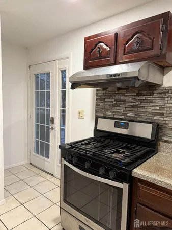 a stove top oven sitting inside of a kitchen