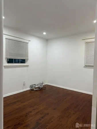 a view of a room with wooden floor and cabinet