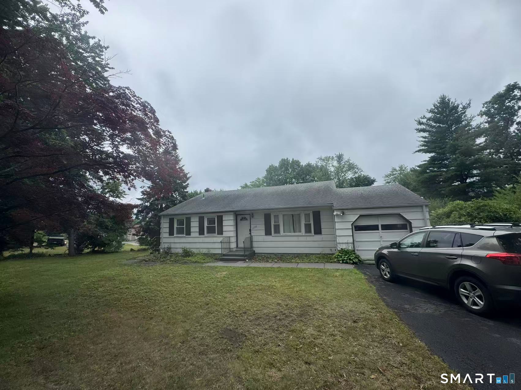 1122 Fienemann Road Farmington, CT 06032 - Photo 1 of 26 a view of house with a big yard and large trees