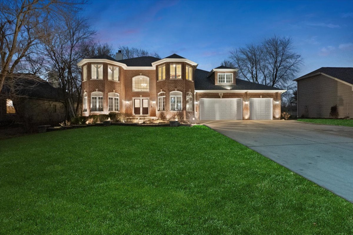 325 Williams Street Roselle, IL 60172 - Photo 1 of 40 a front view of a house with a garden and yard