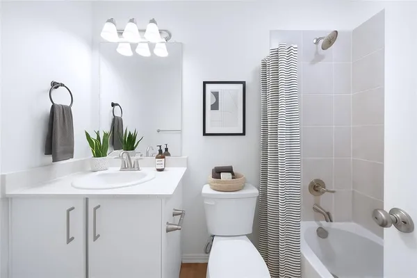 a bathroom with a sink toilet and shower