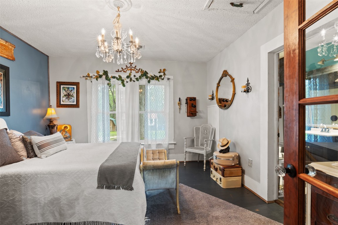 10960 McDowell Road Conroe, TX 77306 - Photo 11 of 25 Charming bedroom with elegant lighting, natural light, and timeless character details.