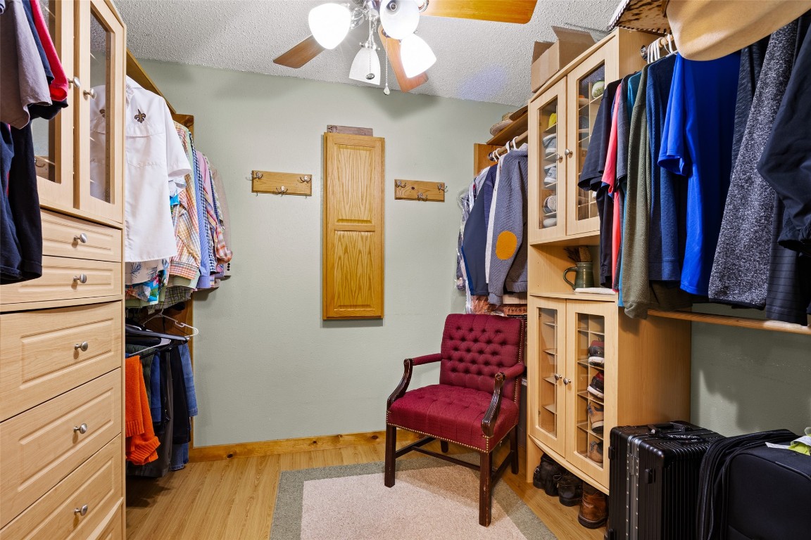 10960 McDowell Road Conroe, TX 77306 - Photo 17 of 25 2nd walk in closet in the primary bedroom,. Complete with a fold down ironing board and built ins.