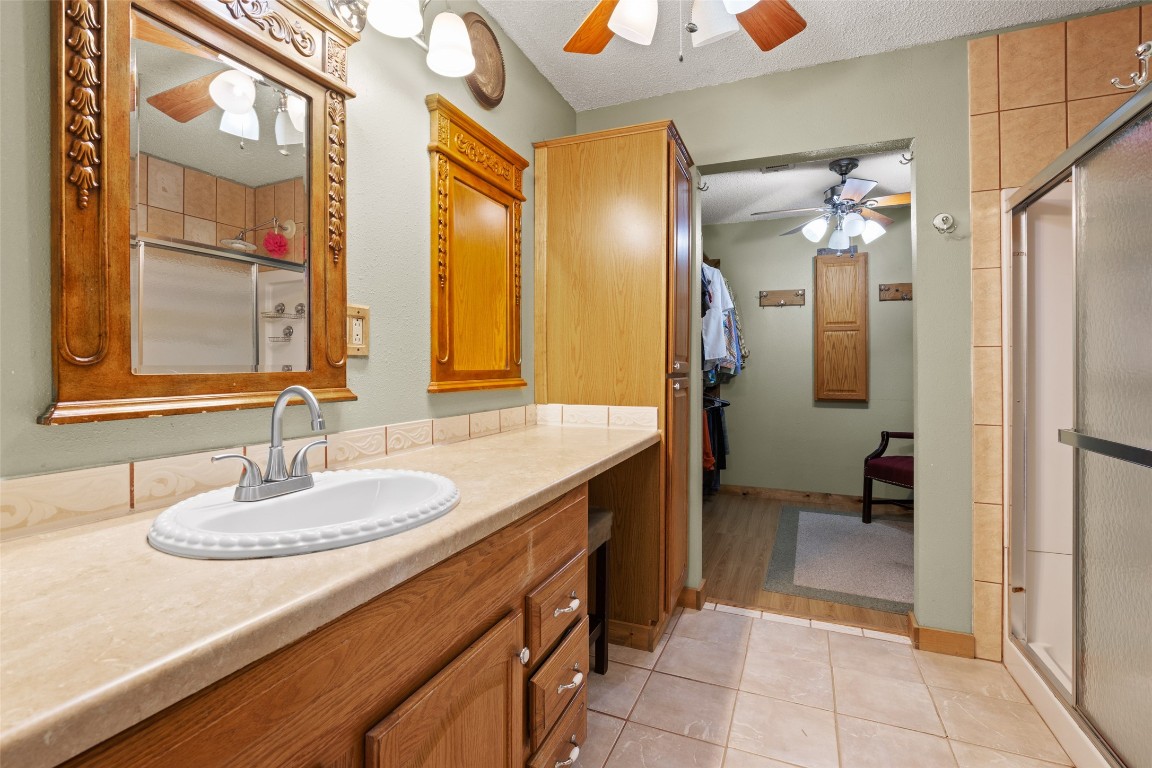 10960 McDowell Road Conroe, TX 77306 - Photo 18 of 25 Spacious primary bathroom with extended vanity, abundant storage, and direct access to the walk-in closet.