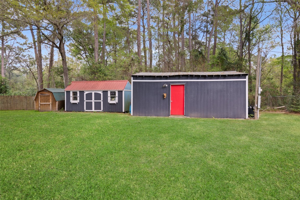 10960 McDowell Road Conroe, TX 77306 - Photo 24 of 25 Multiple storage buildings offering flexibility for hobbies, workspace, or extra storage.