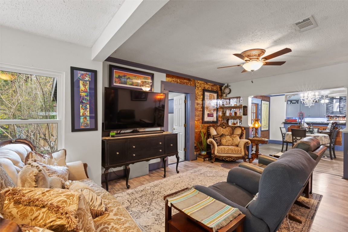 10960 McDowell Road Conroe, TX 77306 - Photo 5 of 25 Cozy living area with warm wood accents, natural light, and open flow into the dining and kitchen spaces.