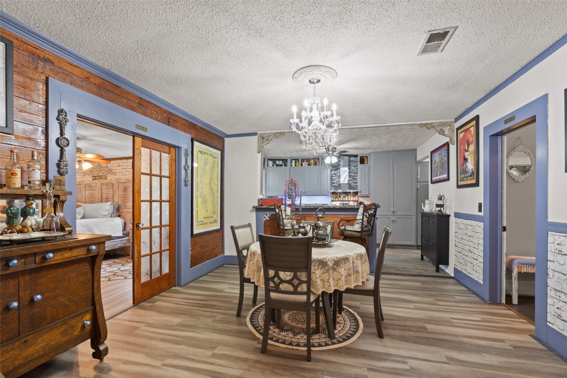 10960 McDowell Road Conroe, TX 77306 - Photo 6 of 25 Warm and inviting dining space featuring charming details and open flow to the kitchen.Seamless connection between kitchen and dining—perfect for entertaining.