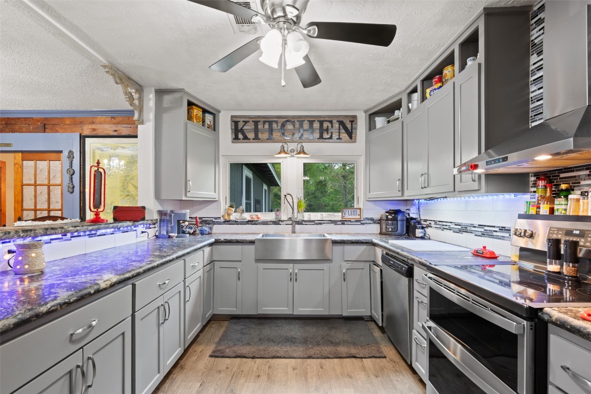 10960 McDowell Road Conroe, TX 77306 - Photo 7 of 25 Spacious layout with farmhouse sink, modern finishes, and functional workspace.