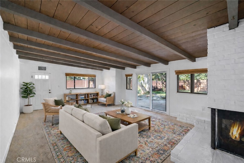Family Room from entrance off of Kitchen. Door to driveway in back. Door to backyard on the right. Virtually staged.