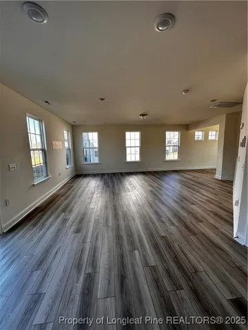 a view of wooden floor and windows in an empty room