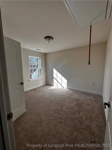 a view of an empty room and a window