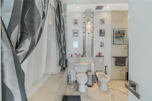 a bathroom with a sink a toilet and a shower