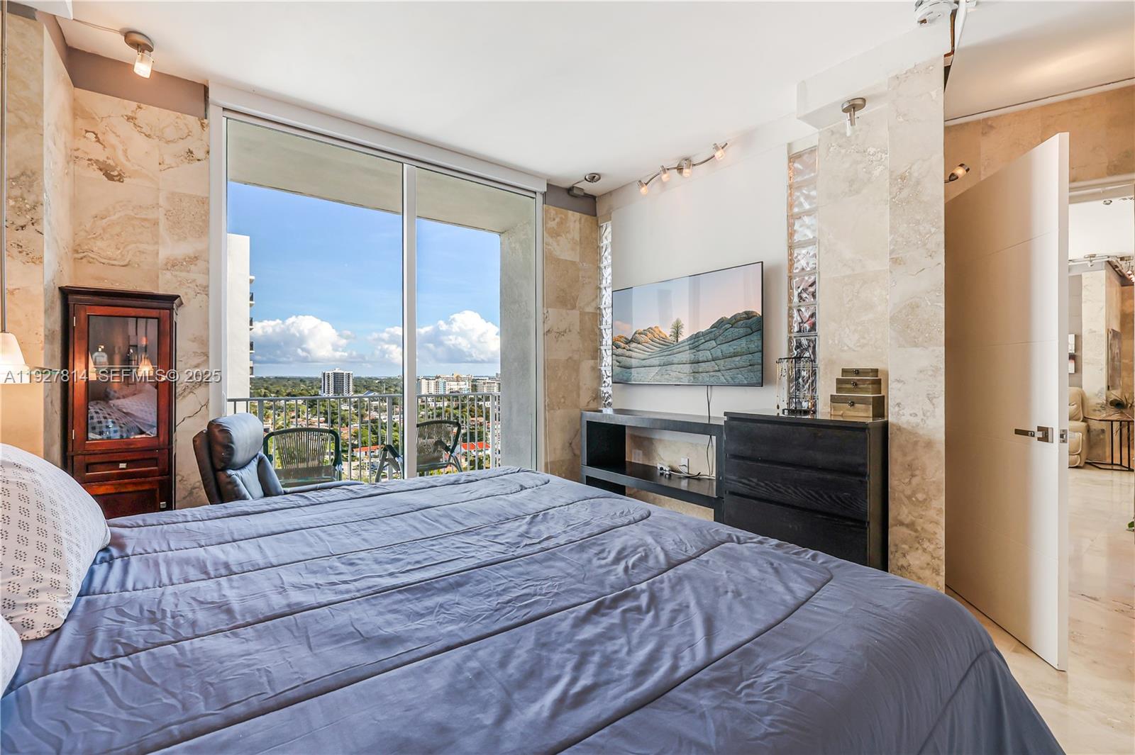 3180 Southwest 22nd Terrace, Unit PH201 Miami, FL 33145 - Photo 21 of 58 a bedroom with a large bed and a large window