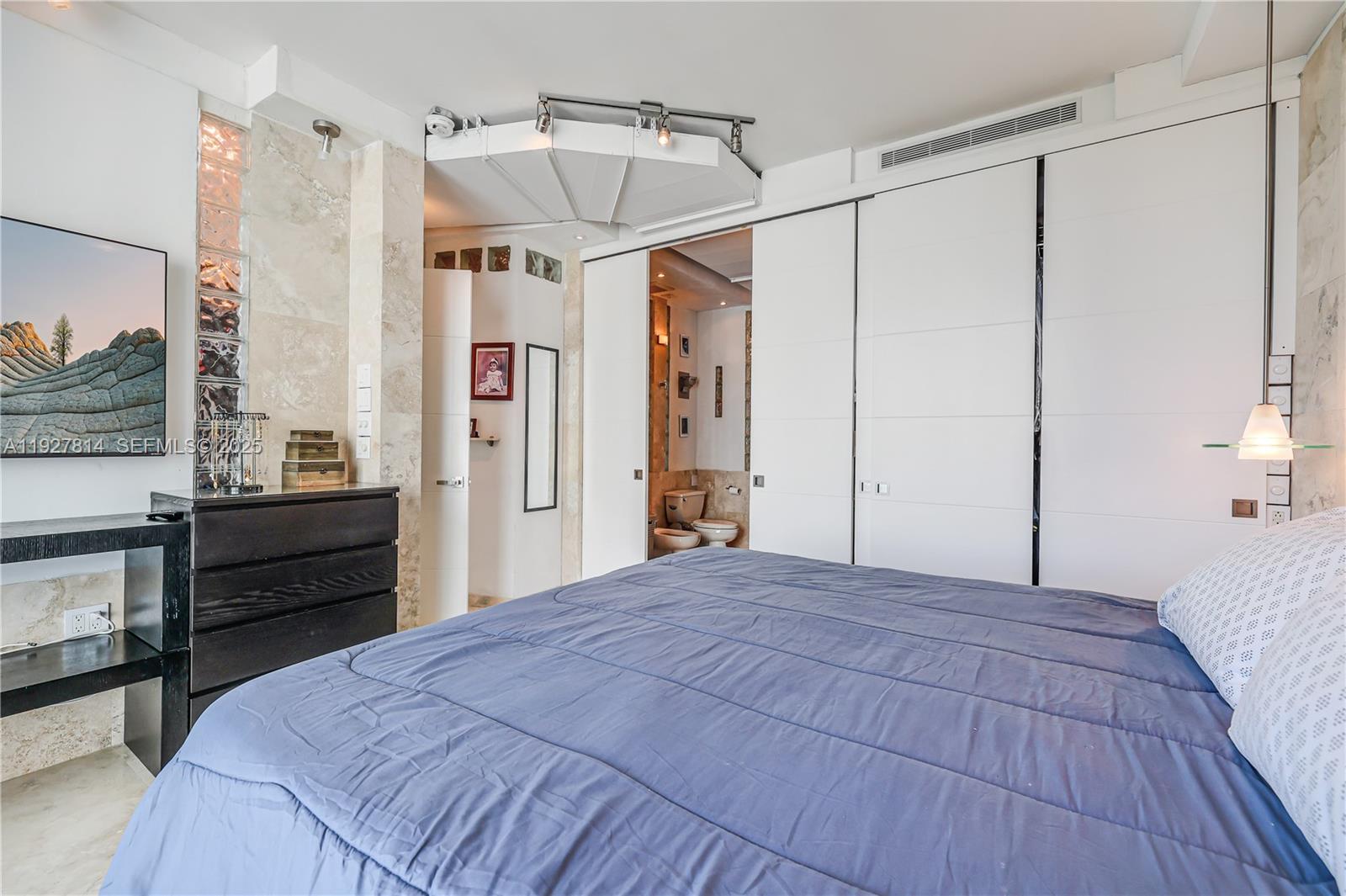 3180 Southwest 22nd Terrace, Unit PH201 Miami, FL 33145 - Photo 23 of 58 a bedroom with a bed and a dresser