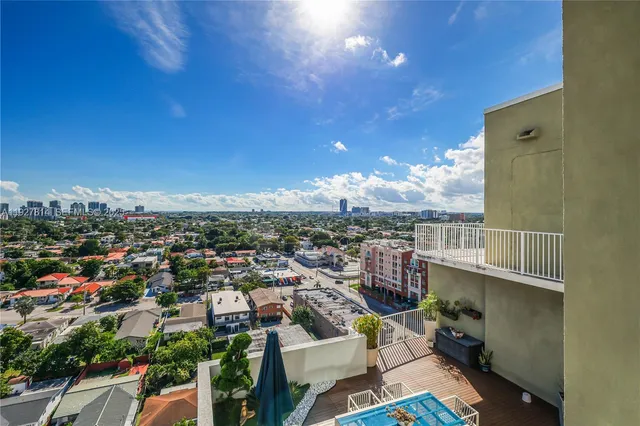 a bedroom with a bed and large windows