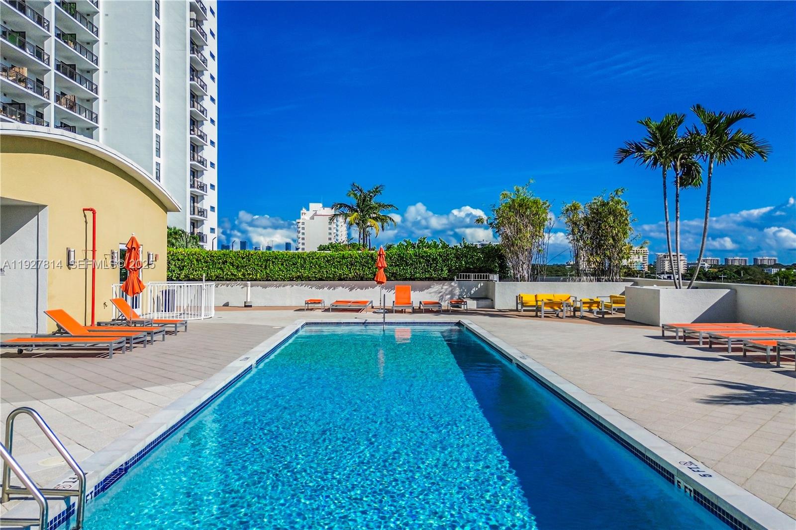 3180 Southwest 22nd Terrace, Unit PH201 Miami, FL 33145 - Photo 50 of 58 a view of swimming pool with chairs and potted plants