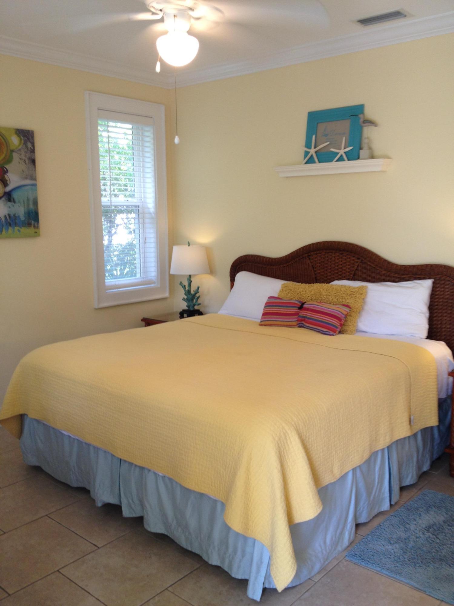 89 West Blue Crab Loop Inlet Beach Inlet Beach, FL 32461 - Photo 13 of 42 a bedroom with a bed and a chandelier