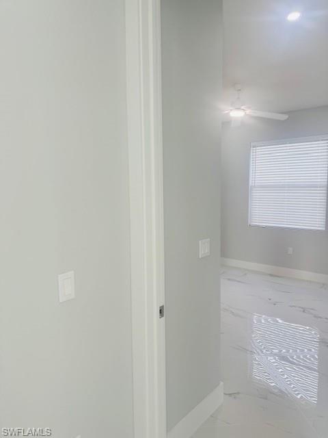 165 Patio Street Lehigh Acres, FL 33974 - Photo 33 of 34 Hallway featuring light marble finish floors and baseboards