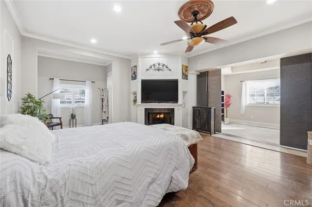 a spacious bedroom with a bed and a flat screen tv