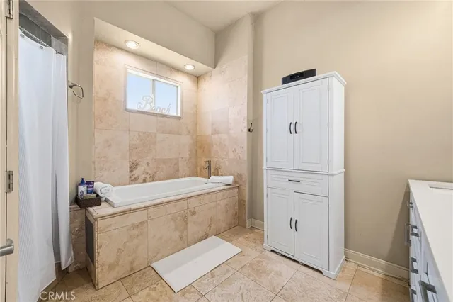 a bathroom with a granite countertop sink vanity and mirror