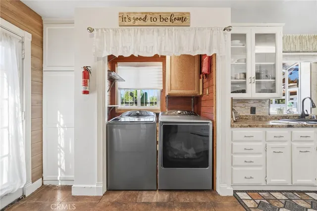 a kitchen with stainless steel appliances a refrigerator sink and cabinets